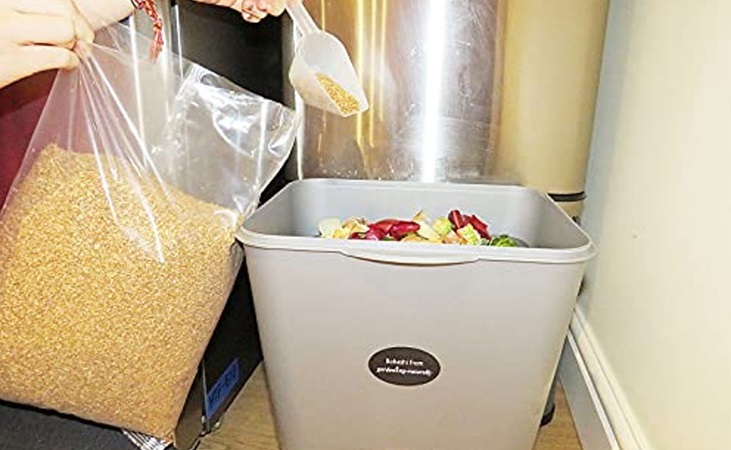 Adding Bokashi bran to a Bokashi bin