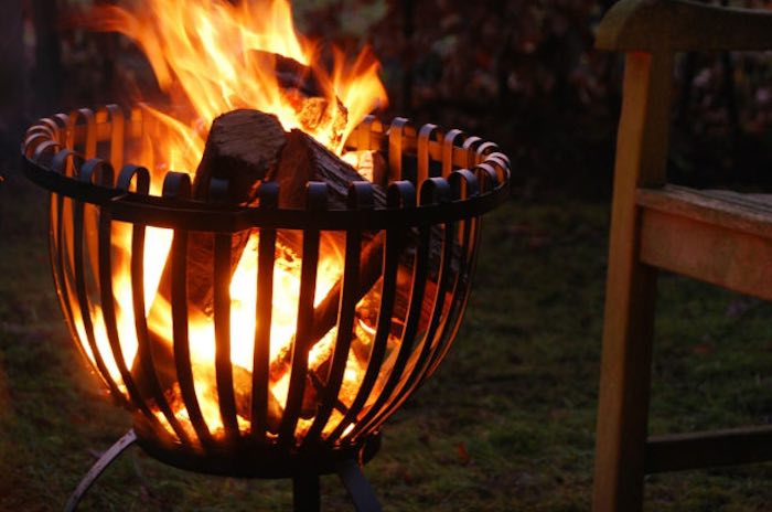 Flames visible through a brazier fire basket