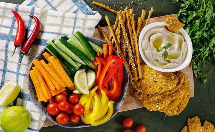 Vegetables cut into snack-friendly strips with some dip.