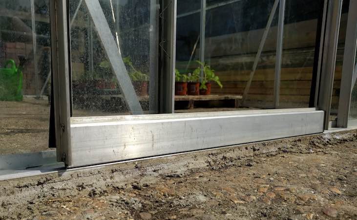 The base of a greenhouse sliding door