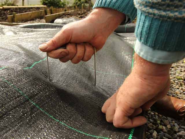 Locking down mypex weed control fabric