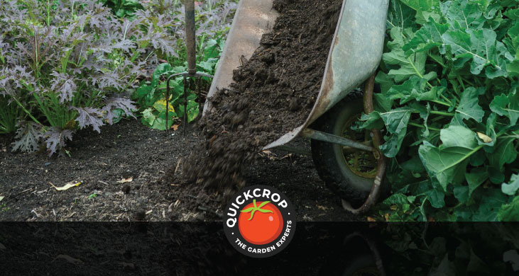 Using a wheelbarrow to add compost to the garden - header image