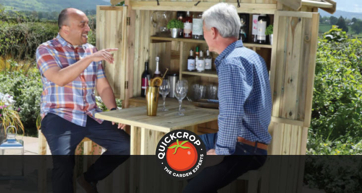 Two men sitting and chatting at a garden bar - header image