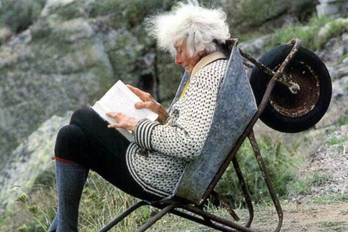 Rowena Cade sitting in a wheelbarrow